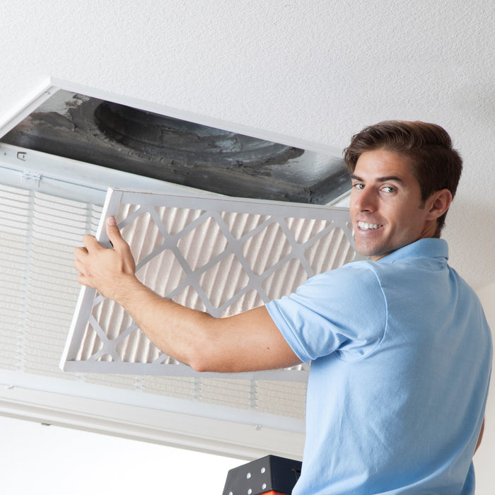 A man showing the different air filter sizes