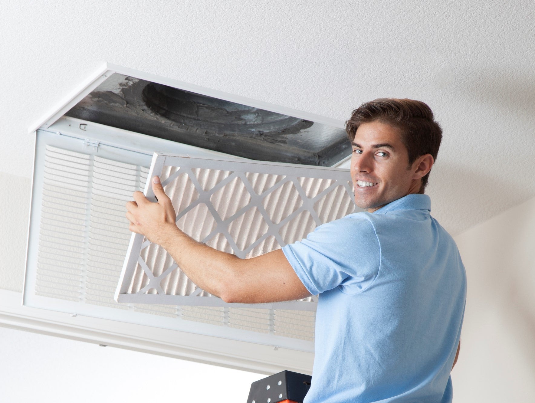 A man showing the different air filter sizes