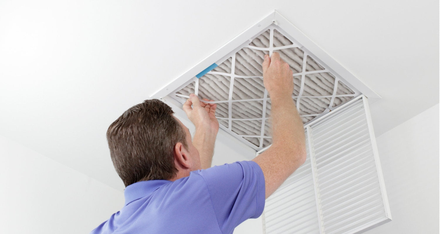 Man replacing a Carrier 1" Air Filter