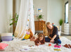 Woman playing with child with Carrier Smart Room Air Purifier in the background